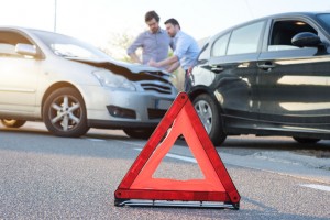 Two men reporting a car crash for insurance claim