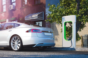 Electric white modern car near Electric car charging station at street. 3d rendering